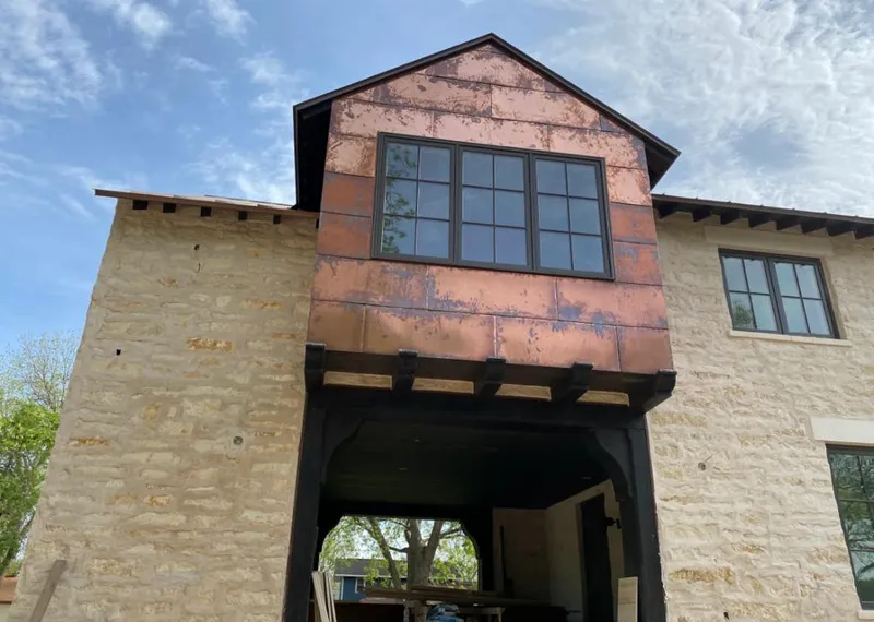 Copper metal panel facade on a stone building for Skylight Installation in Henrietta